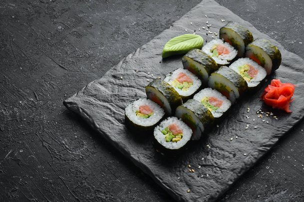 Sushi rolls with avocado and salmon. Classic Japanese sushi. Top view. Free space for your text. - Foto, Imagem