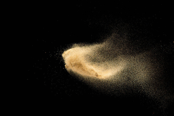 Brown colored sand splash.Dry river sand explosion isolated on black background. Abstract sand cloud. - Photo, Image