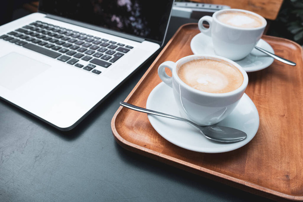 Coffee cup and laptop for business, Selective focus on coffee. - Foto, Bild