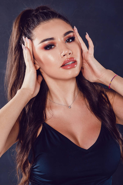 Portrait of a sexy young woman with beautiful makeup and ponytail hair. - Foto, Imagem