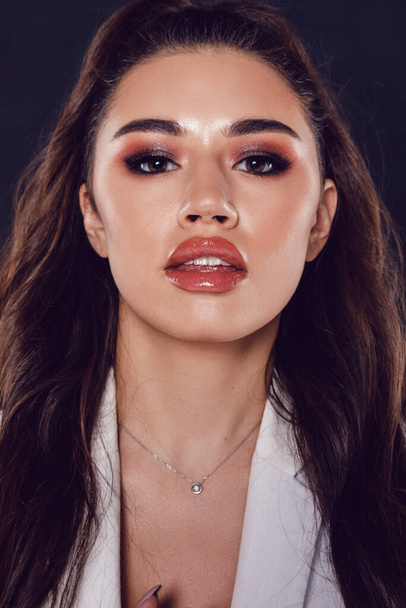 Portrait of a sexy young woman with beautiful makeup and shiny lips. - Photo, Image