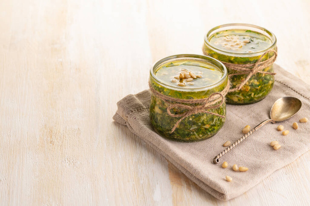 Green pesto sauce. Classic Italian Greens Sauce. Preservation in a glass jar. Close up.  - Fotografie, Obrázek