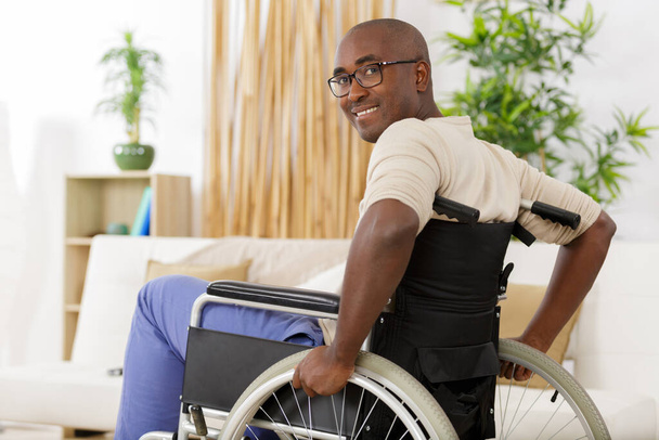 man in wheelchair at home - Foto, imagen