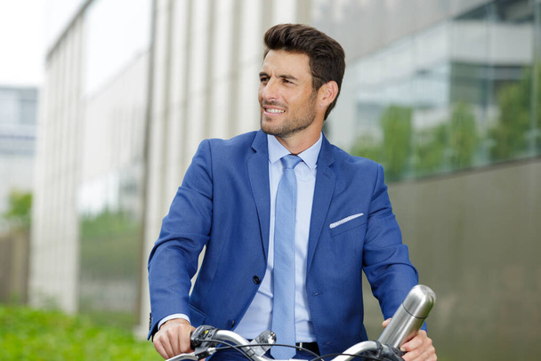 young businessmen with a bike - Fotó, kép