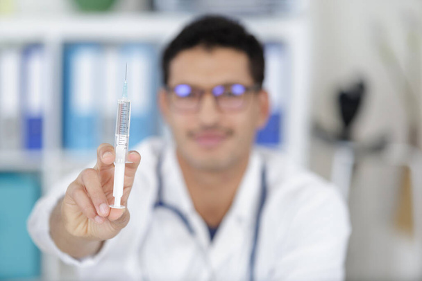 close up of doctor holding syringe with injection - Foto, Imagem
