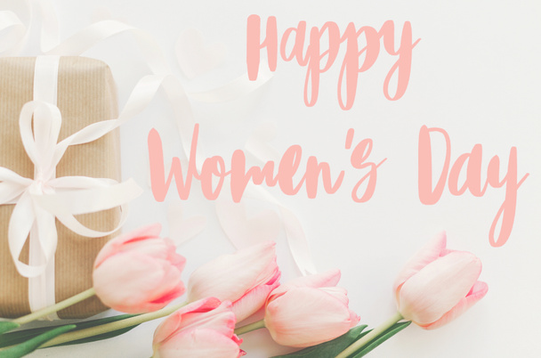 Happy womens day.  Happy women's day text on pink tulips with gift box on white background. Stylish tender image. Handwritten lettering. International women day, 8 march - Photo, Image