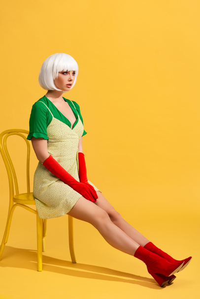 beautiful girl in white wig sitting on chair - 写真・画像