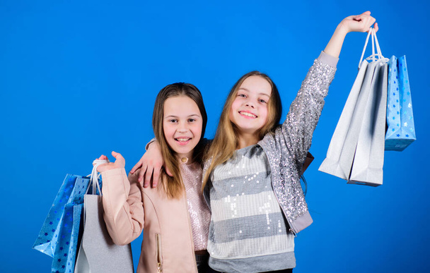 Happy children. Little girl sisters enjoying online shopping. Small girls with shopping bags. Sales and discounts. Sisterhood and family. savings on purchases. Kid fashion. Home shopping - Zdjęcie, obraz