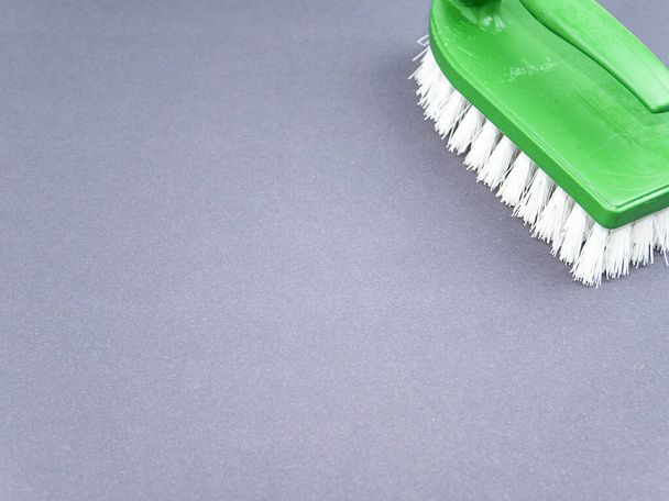Clothes brush with white bristles on a gray background. Tool. Place for text. Background image. - Foto, afbeelding