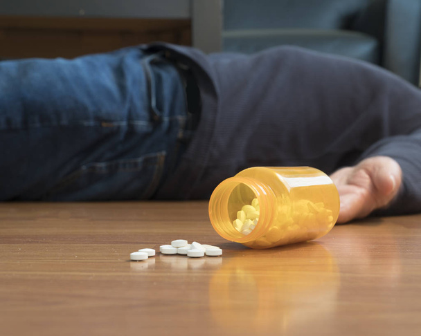 Intento de suicidio como lo ilustra un cuerpo tendido en el suelo por una sobredosis
 - Foto, imagen