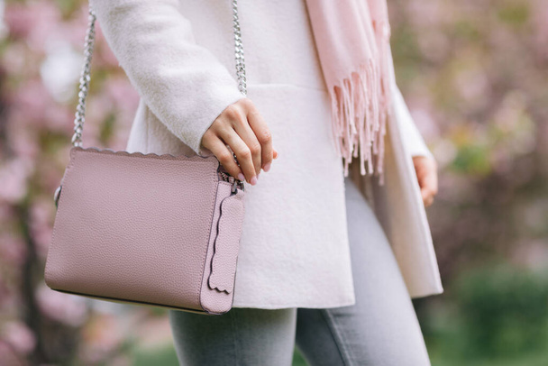 woman in white coat, scarf and pink handbag - Photo, image
