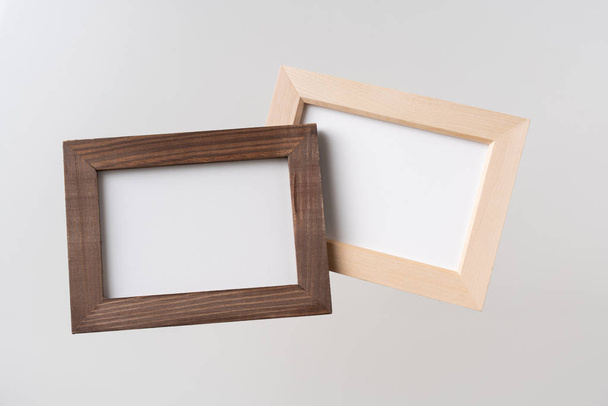 Design concept - top view of two brown wood photo frame float on mid air and isolated on white background for mockup, it's real photo, not 3D render - Foto, imagen