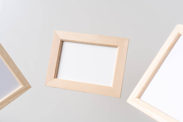 Design concept - top view of three brown wood photo frame float on mid air with blur effect isolated on white background for mockup, it's real photo, not 3D render - Foto, Bild