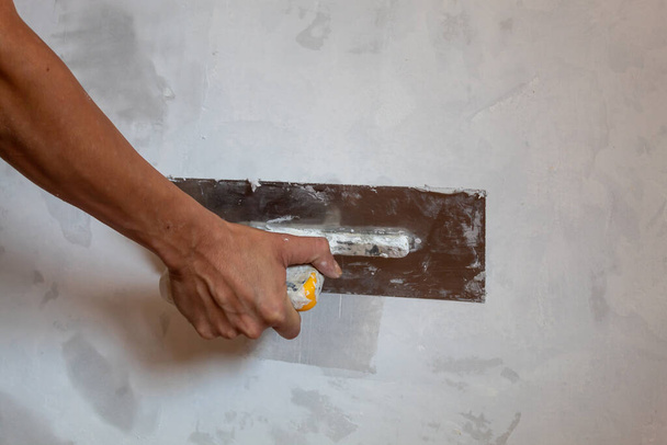Woman Hand Holding a Trowel For Plaster - Photo, Image