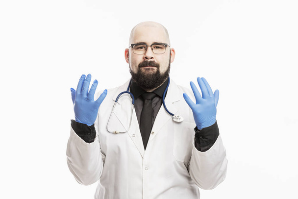 Male doctor in a white medical coat and blue latex gloves. White background. - Foto, immagini