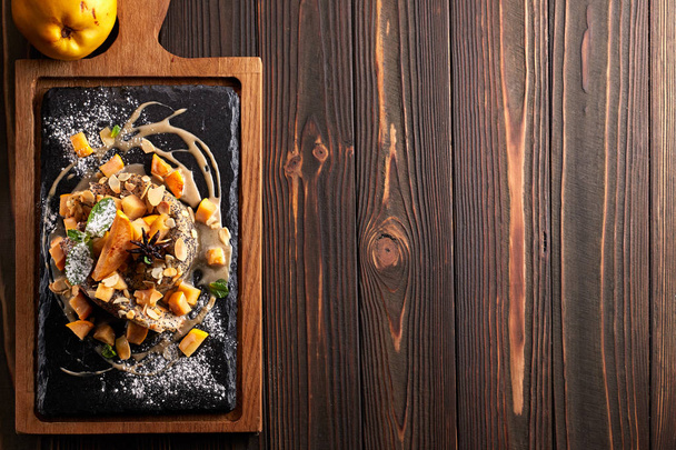 Pancakes with salmon, on a black stone, slate, on a wooden board. Top view - Foto, afbeelding