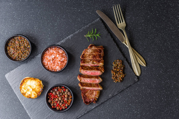 New york strip loin beef steak meat with chimichurri sauce. - Zdjęcie, obraz