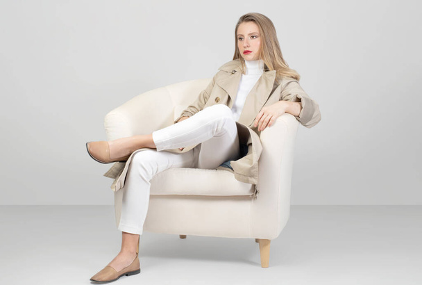 Fashionable clothes. Beautiful fashion woman in trench coat and pant in studio - Valokuva, kuva