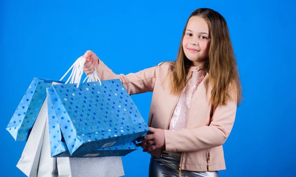 Happy child. Little girl with gifts. Small girl with shopping bags. Sales discounts. Holiday purchase saving. Kid fashion. shop assistant with pack. birthday shopping. happy birthday. birthday gift - Photo, image