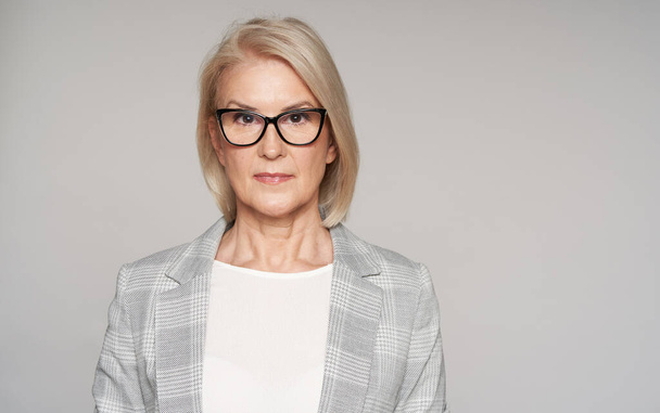 portrait of beautiful older business woman is wearing eyeglasses and smiling. Isolated - Foto, Bild