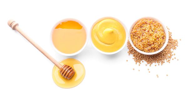 Bowls of honey, mustard and sauce on white background - Photo, Image