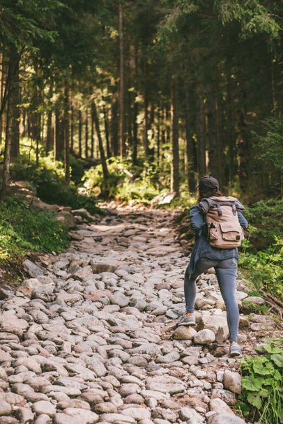 woman with backpack hiking in forest by stone path trail travel concept - Φωτογραφία, εικόνα