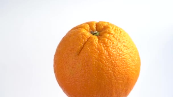 Orange on a white background. Ripe big fruit. - Imágenes, Vídeo