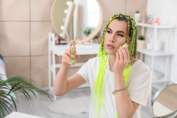 Transgender woman applying makeup at home - Foto, Bild