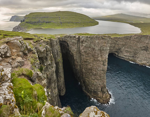 Dramatic atlantic rocky coastline cliffs landscape in Vagar. Faroe islands - Photo, Image