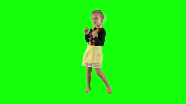 Happy young girl dancing and smiling over green background. - Filmmaterial, Video