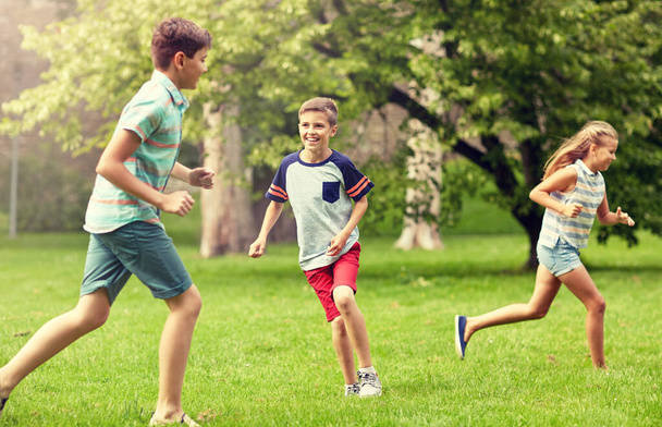 happy kids running and playing game outdoors - Foto, immagini