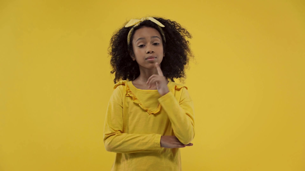 pensive african american kid having idea isolated on yellow  - Felvétel, videó