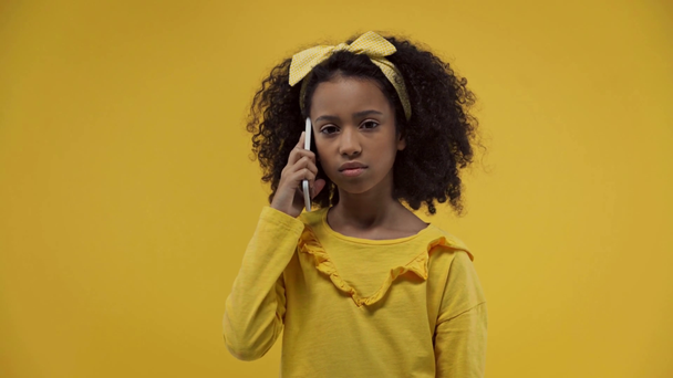 african american kid talking on smartphone isolated on yellow  - Video, Çekim
