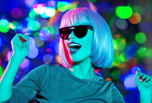 happy woman in pink wig and sunglasses dancing - Foto, Imagem