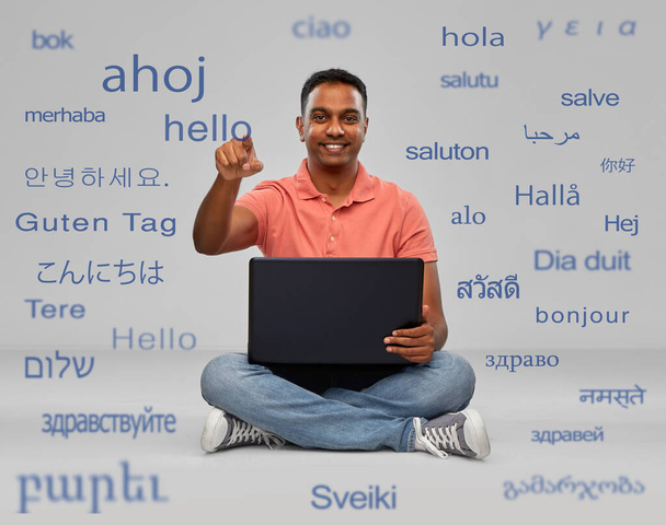 happy indian man with laptop learning languages - Photo, image