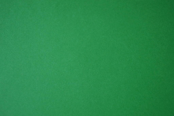 bright natural background  green grass on a sheet of paper the texture of cardboard - Foto, Bild