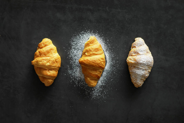 Fresh pastries on the table. French flavored croissant for breakfast. - Foto, afbeelding