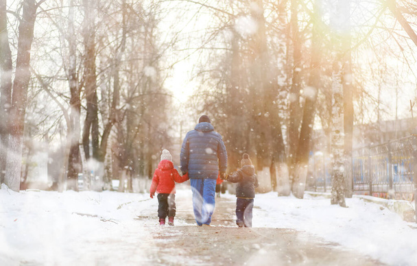 Children with grandpa play outside in the winter. Snow games in the street. - Photo, Image
