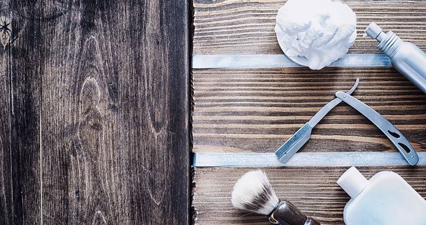 Shaving accessories on a wooden texture background. Tools. Disposable shaving machine, brush, foam hazard razor. - Foto, immagini