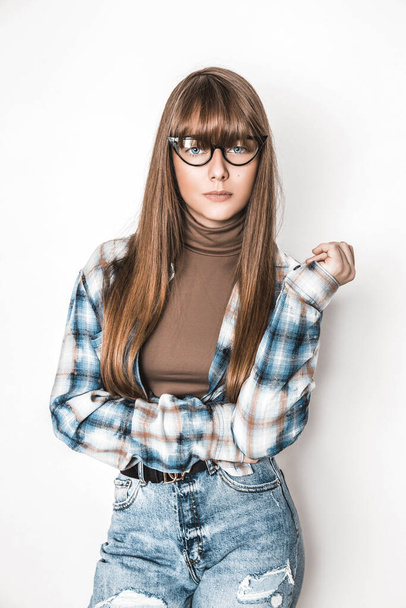 Beauty young girl with long smooth hair and  glasses on white background. Young model with eyeglasses and trendy bangs - Zdjęcie, obraz
