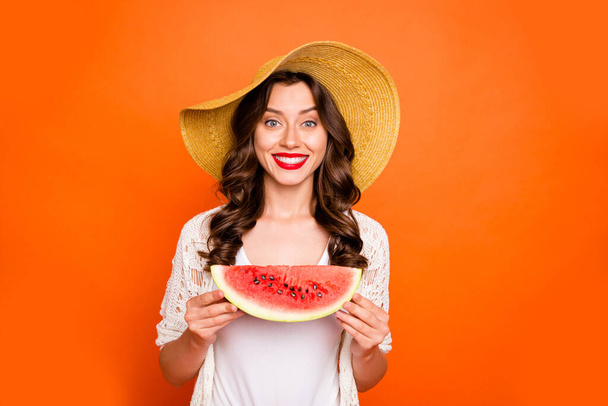 Photo of cheerful positive curly cute nice pretty wavy charming nice girlfriend smiling toothily holding a wedge of watermelon readying to eat it isolated vivid orange color background - Φωτογραφία, εικόνα