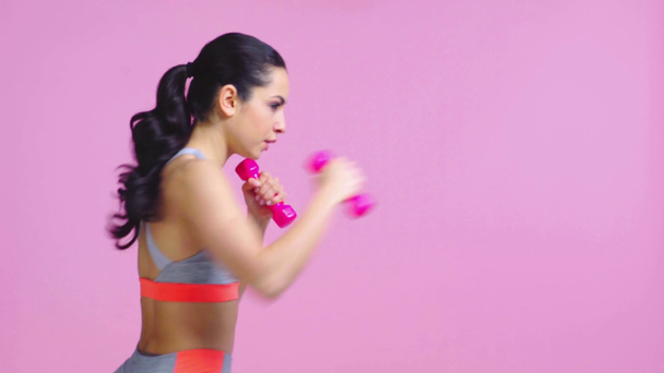 profile of girl boxing with dumbbells isolated on pink  - Footage, Video