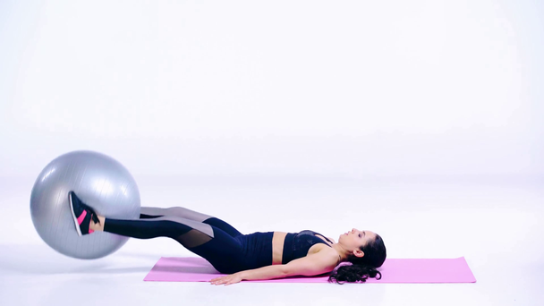 sportive girl exercising with fitness ball on white  - Materiał filmowy, wideo