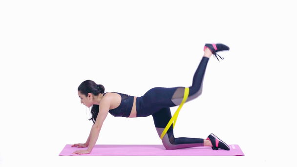 athletic woman exercising with elastics isolated on white  - Πλάνα, βίντεο
