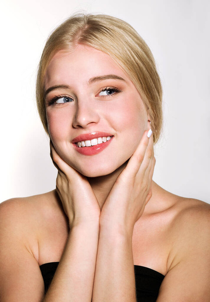 Portrait of beautiful blonde young woman face.  Spa model girl with fresh clean skin isolated on a white background. Skin and hair care concept - Φωτογραφία, εικόνα