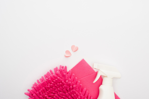 top view of pink cleaning supplies and hearts on white background - Zdjęcie, obraz