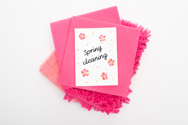 top view of pink cleaning supplies and spring cleaning card on white background - Fotoğraf, Görsel