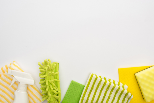 top view of green and yellow cleaning supplies on white background - Photo, Image