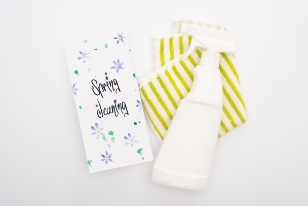top view of cleaning supplies near spring cleaning card on white background - Photo, Image