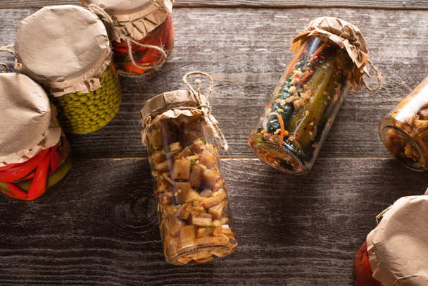 木のテーブルの上の瓶に自家製のおいしい漬物のトップビュー - 写真・画像